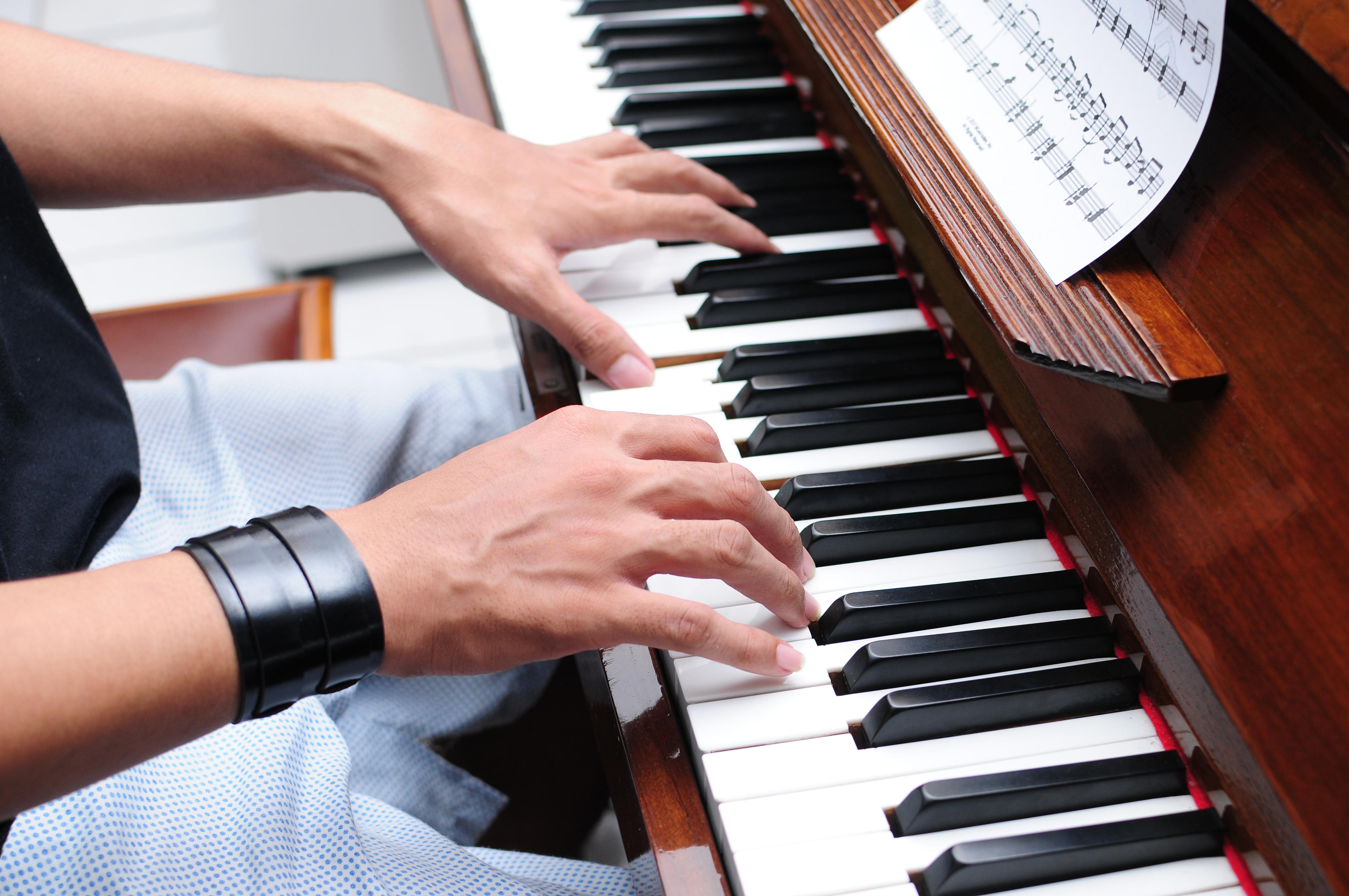 image cover: a man playing at piano